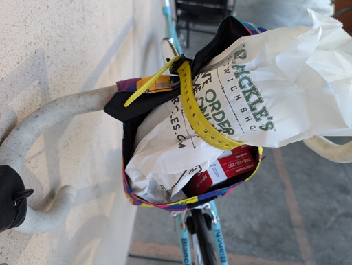 Sandwich (in bag) doesn't fit in handlebar bag, but yellow strap secures it anyway