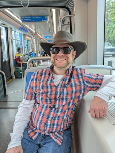 Handsome man riding a tram.